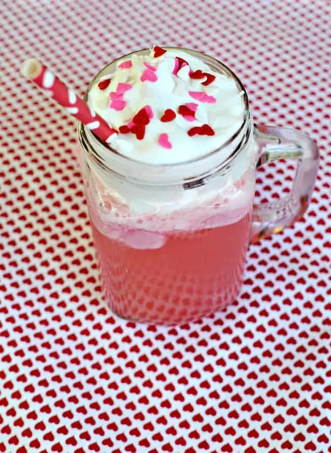 Celebrate the day of love with this yummy Valentine's Day Party Punch recipe. This "love potion" recipe is a favorite and very simple punch recipe. One that would be perfect for baby showers, weddings and of course Valentine's Day. #PunchRecipe #PartyPunch #LovePotion #ValentinesDay #ValentinesDayDrinks