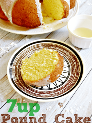 A slice of 7UP Pound Cake on a dessert plate with the whole cake set to the side.