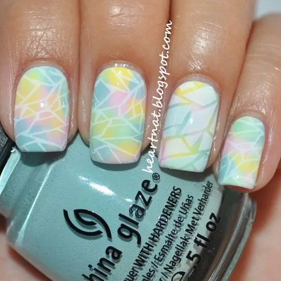 Mosaic nails with green, yellow, and pink color.