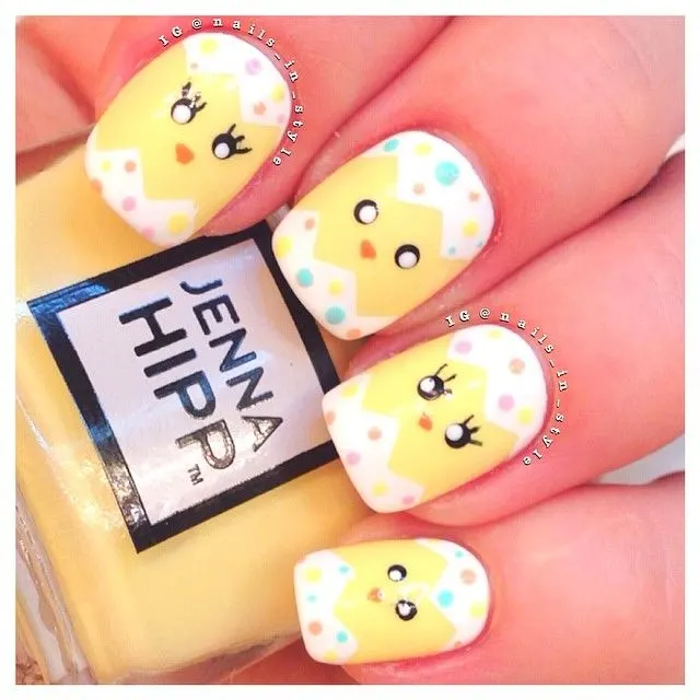 Easter nails that look like chicks hatching out of white polka-dotted eggs.