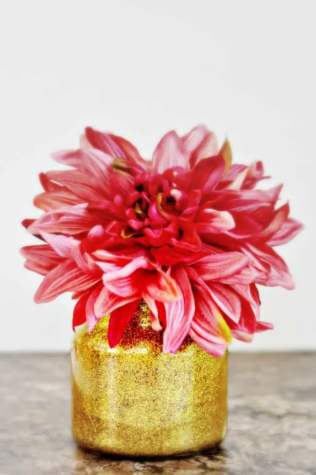 Jazz up your home with this diy glitter vase, perfect for recycling old candle jars.