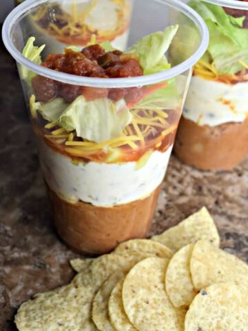 This easy 7 layer dip recipe is perfect for any game day get together. It is super easy to throw together in just 30 minutes.