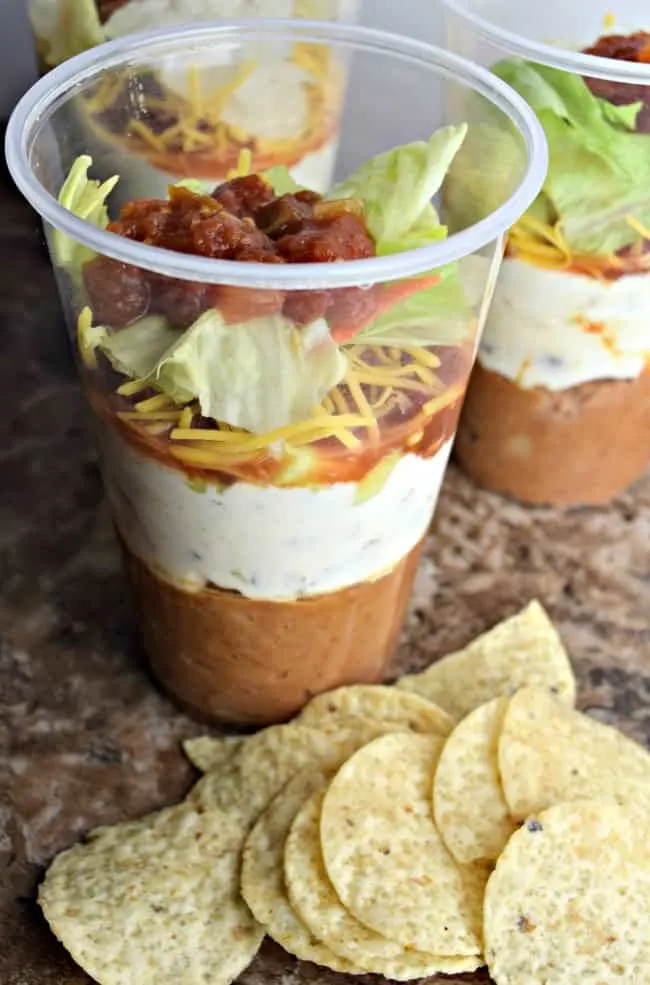 Photo of the 7 layers in this dip with a side of tortilla chips that you would use with the dip.