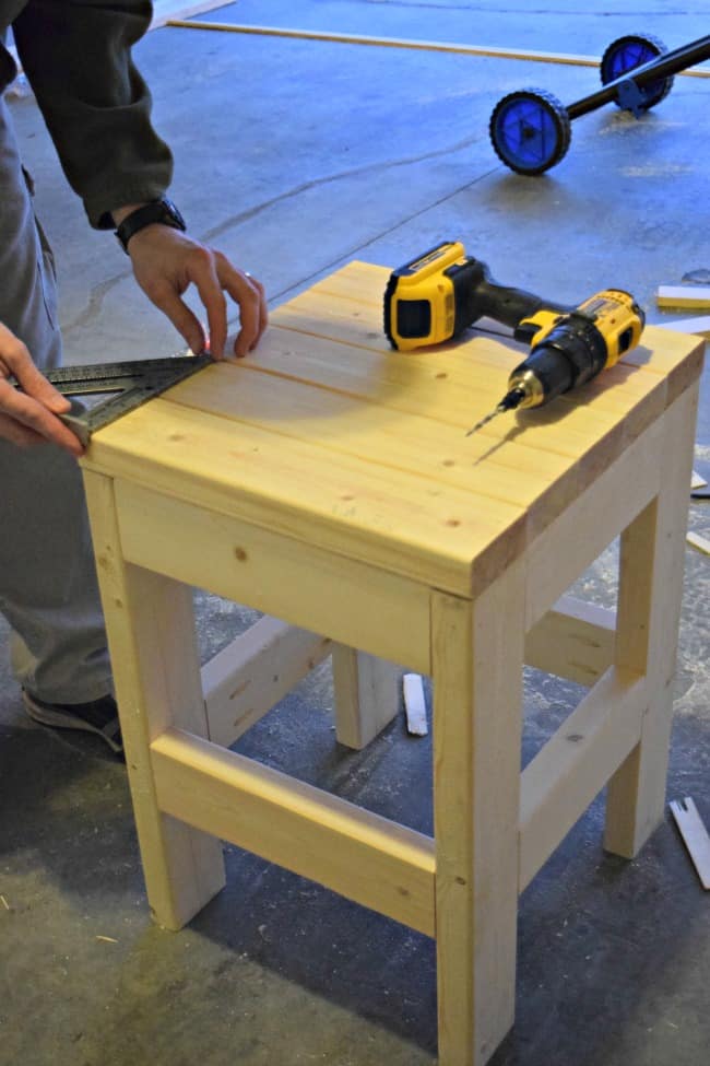 Make this easy DIY Shop Stool using only 3 - 2x4x8 boards. The cost is less than $10. It would also make a great side table or plant stand.