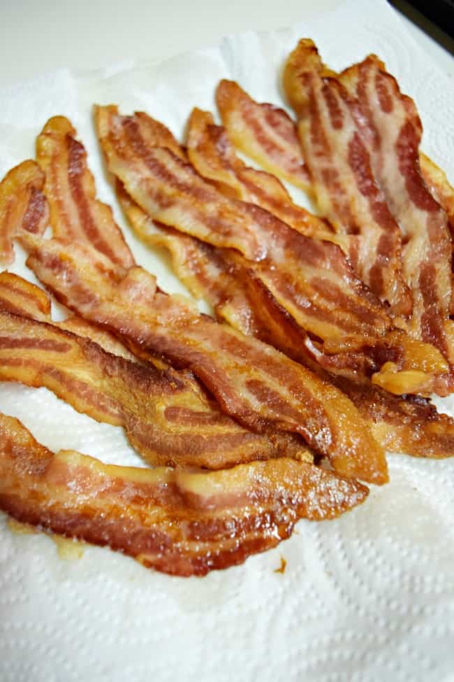 oven cooked bacon on a white paper towel