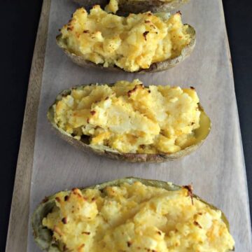 How can you go wrong with an easy twice baked potato recipe with cheese, bacon, green onions and butter? Super simple to make and half the time as the normal method.