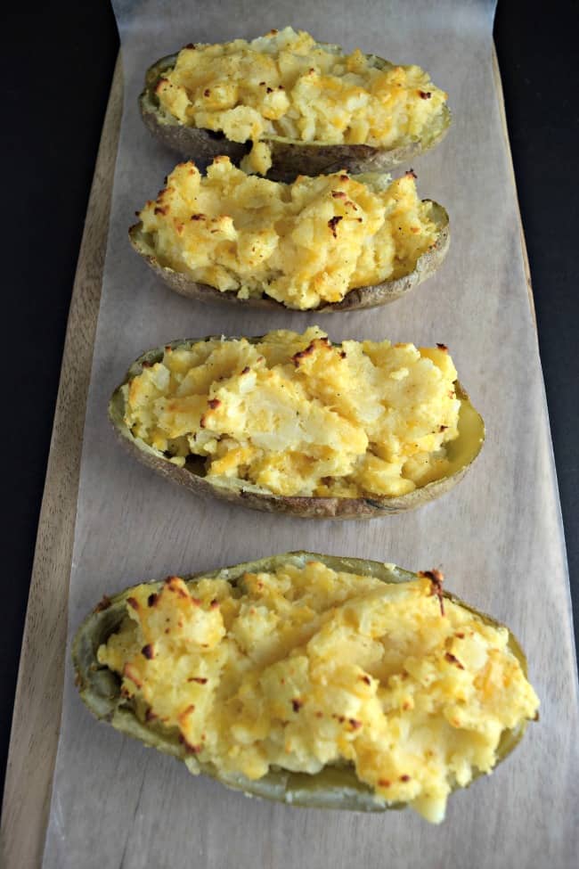 How can you go wrong with an easy twice baked potato recipe with cheese, bacon, green onions and butter? Super simple to make and half the time as the normal method.