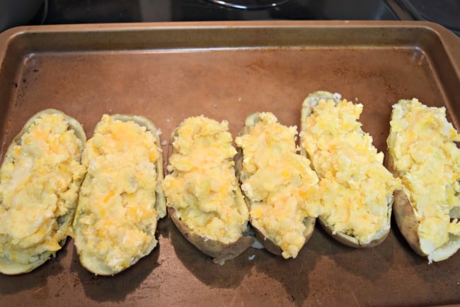 How can you go wrong with an easy twice baked potato recipe with cheese, bacon, green onions and butter? Super simple to make and half the time as the normal method.