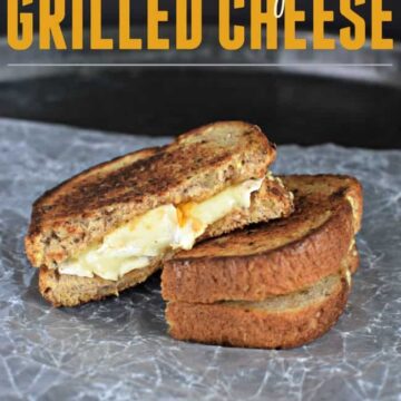 Brie and Apricot grilled cheese sandwich on a crumpled piece of wax paper