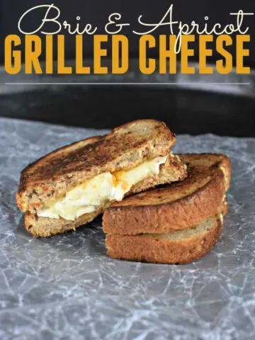 Brie and Apricot grilled cheese sandwich on a crumpled piece of wax paper