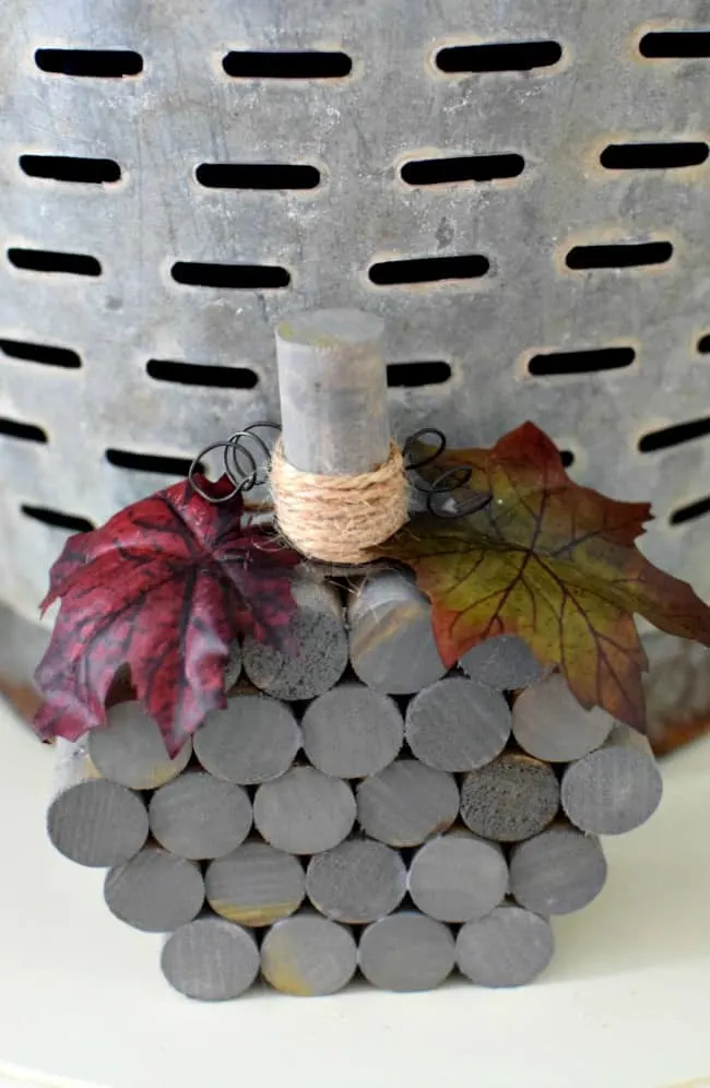 This super simple and inexpensive wooden dowel pumpkin cost less than $5 dollars and 30 minutes to make. Fun homemade fall and Halloween holiday decor!
