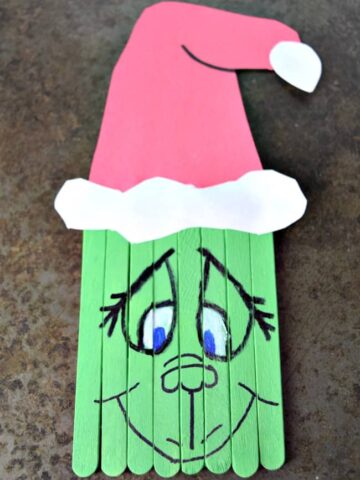 Create this super cute Popsicle Stick Grinch with your kids this holiday season. A perfect pairing with the classic book and movie.