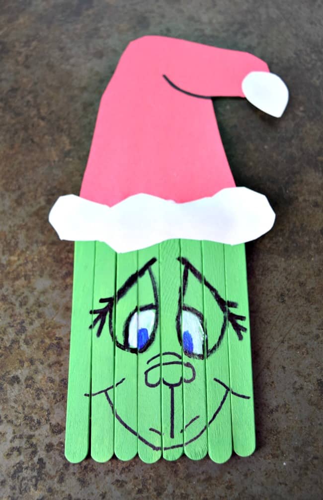 Create this super cute Popsicle Stick Grinch with your kids this holiday season. A perfect pairing with the classic book and movie.