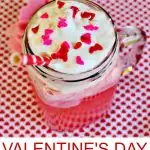 Pink Valentine's Day Punch in a mason jar with red and pink heart sprinkles