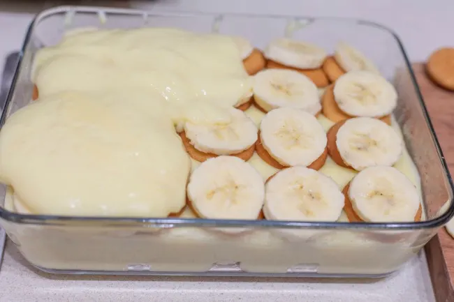 Classic Southern Banana Pudding starts with layering Nilla wafers and perfectly ripe banana slices. Topped with delicious homemade vanilla pudding.