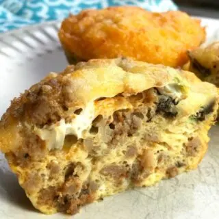 Photo of spicy egg muffins styled on a plate with a cut out of one showing what the inside looks like.Looking for the perfect make-ahead meal for those busy mornings we all seem to have? Well these low-carb, yet super tasty spicy breakfast muffins will do the trick.