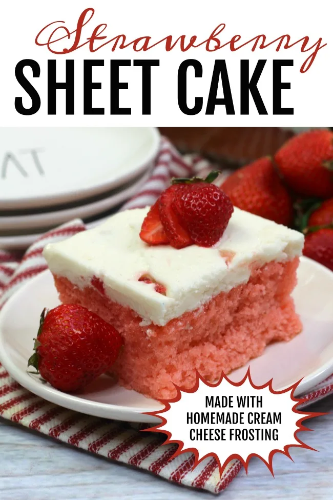 Photo of a piece of Strawberry Sheet Cake on a white plate, layered on top is a sliced strawberry.