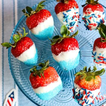This photo features red strawberries decorated in white chocolate and covered with blue and americana sprinkles. They make perfect patriotic strawberries!
