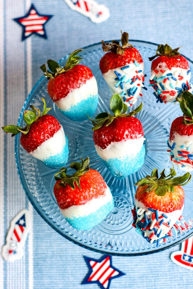 This photo features red strawberries decorated in white chocolate and covered with blue and americana sprinkles. They make perfect patriotic strawberries!