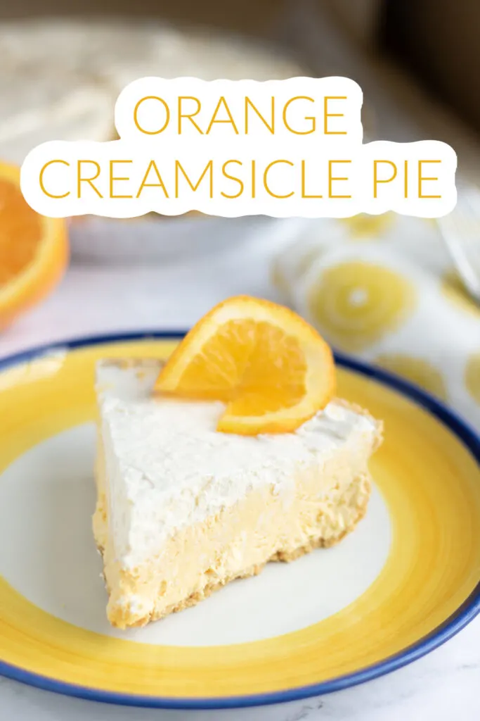 This photo features a slice of Orange Creamsicle Pie on a colorful blue and orange plate.