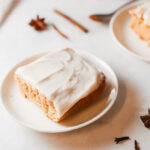 This photo features a slice of homemade pumpkin cake on a white plate.