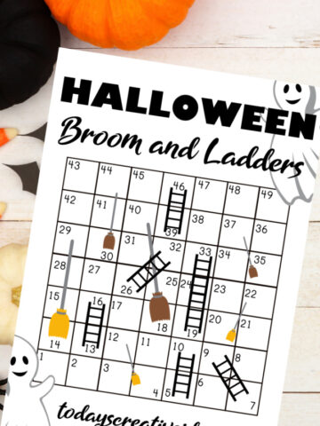 This photo features a image of the printable Halloween game for Kids. It is called Brooms and Ladders.