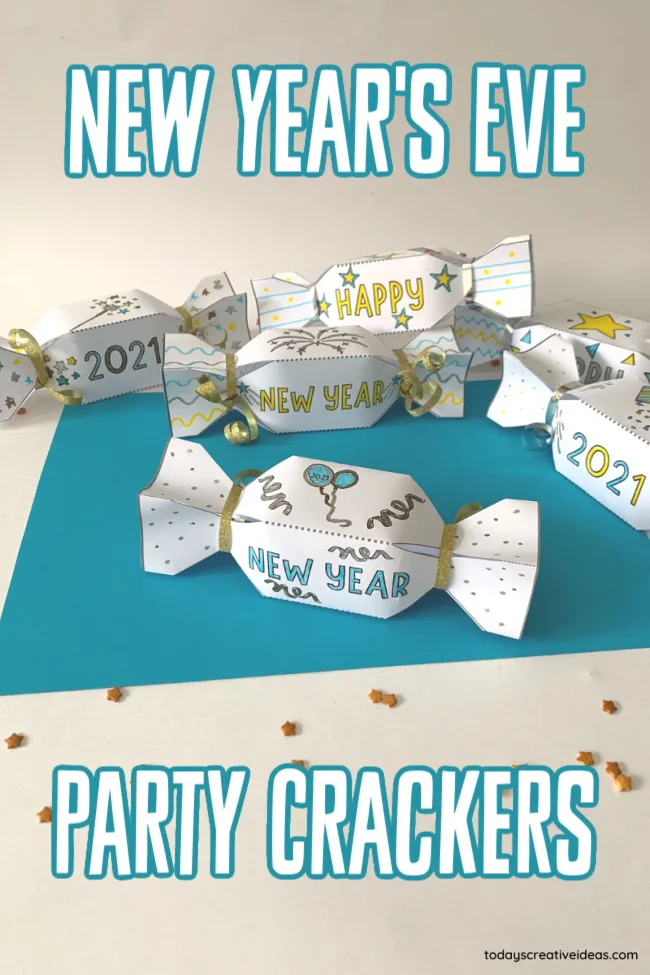 This photo features a blue paper background with some New Year's Eve Party Crackers colored and put together on top.