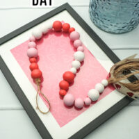 This photo features a made wood bead garland painted up for Valentine's Day.