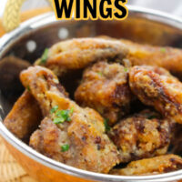 Lemon Pepper Wings in a yellow and stainless steel bowl