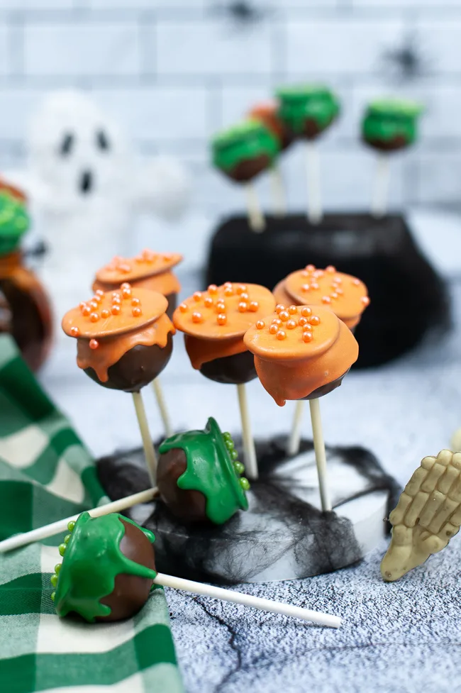 Cauldron Cake Pops done in orange and green icing