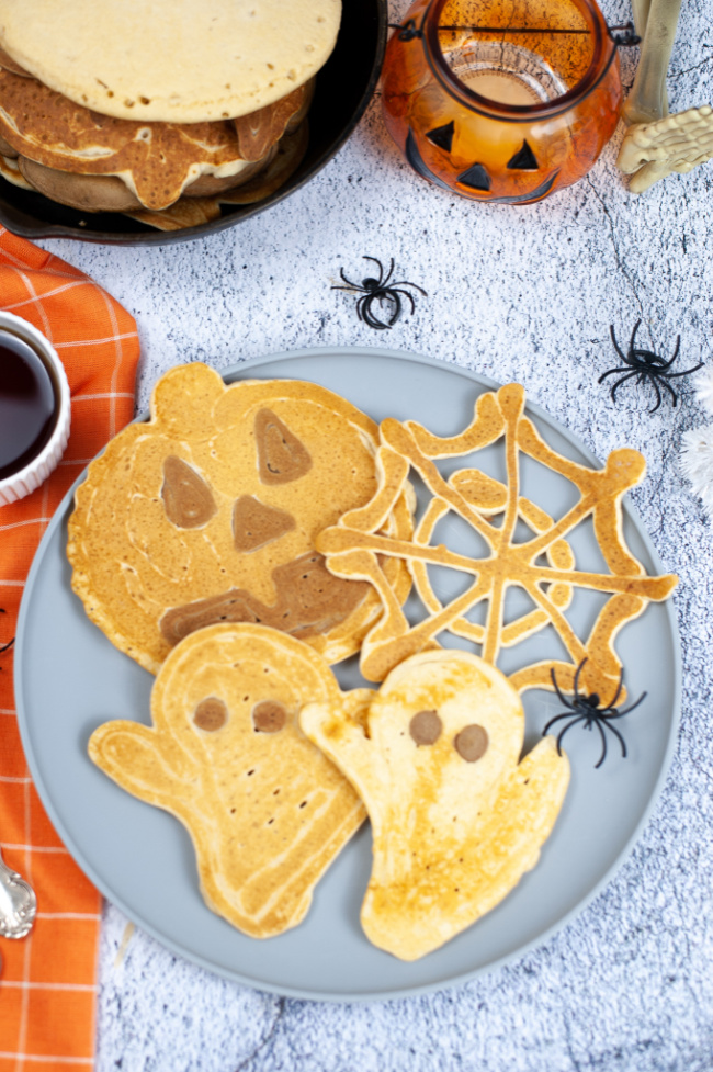 Different shaped Halloween pancakes made from lighter and darker pancake mix.