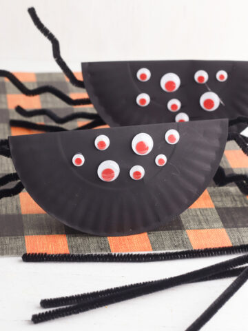 Paper Plate Rockin' Spider Craft on a black and orange background.