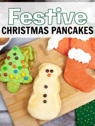 A pancake snowman, tree, and stocking festive Christmas pancakes on a wooden cutting board.