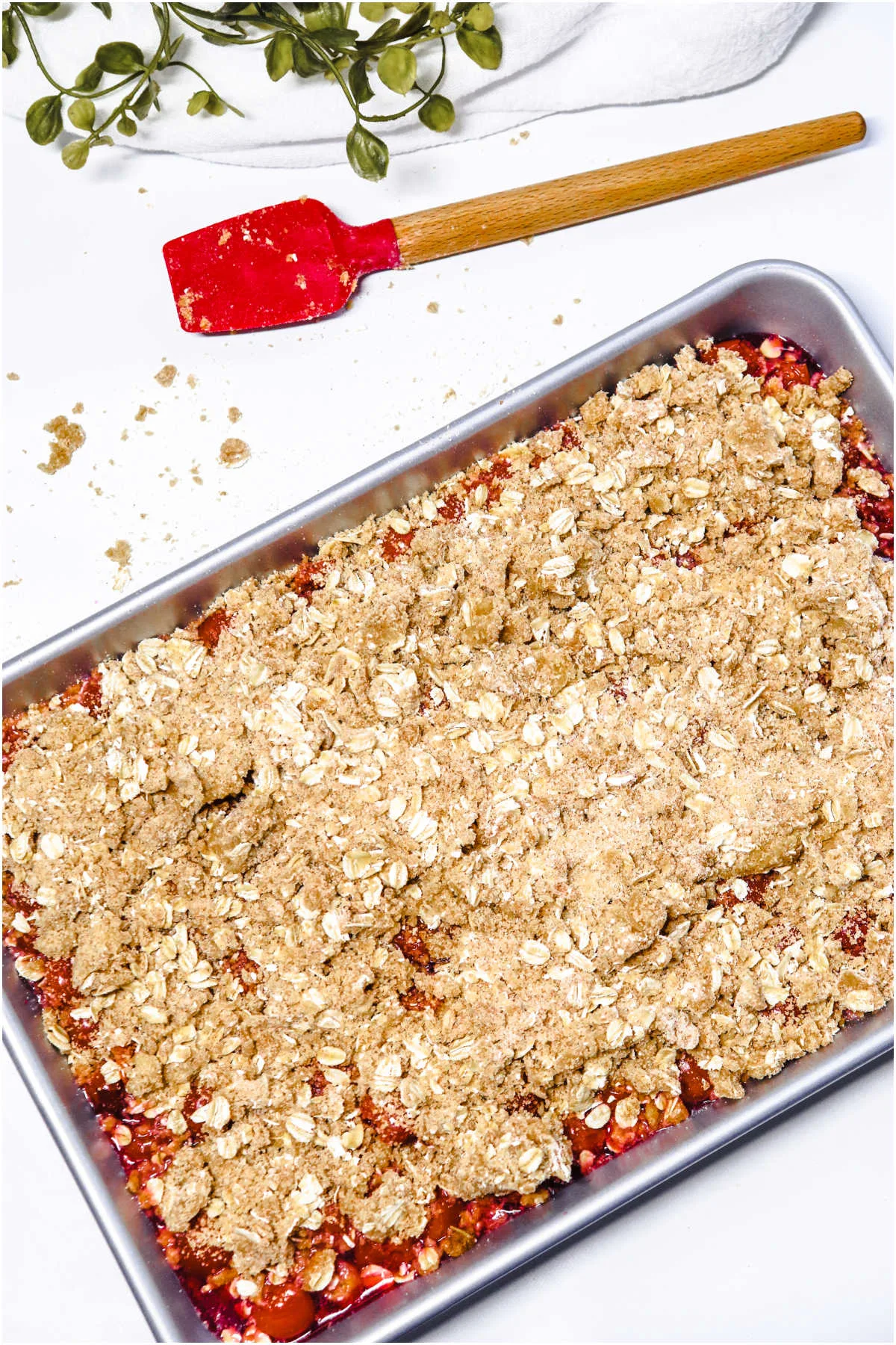 Oat crumbles sprinkled on top of cherry crisp