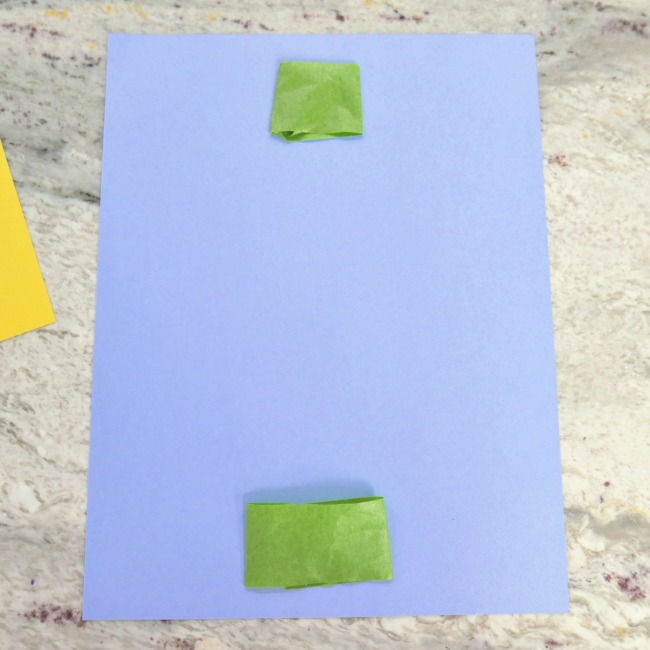 blue piece of construction paper with tape on the top and bottom