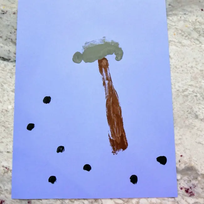 Finished Painted Hammer and nail heads on blue construction paper