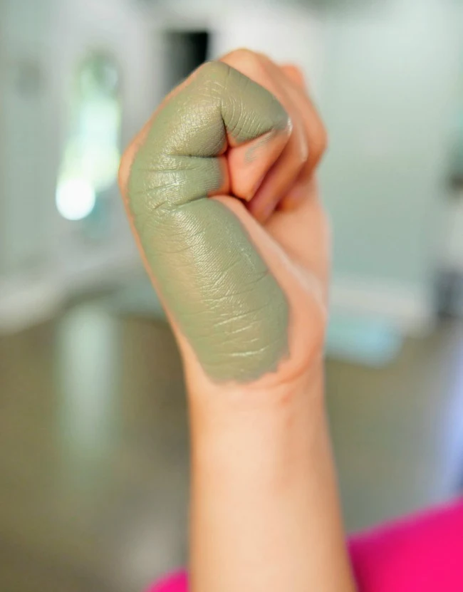 Gray painted on the outside of the hand of a child
