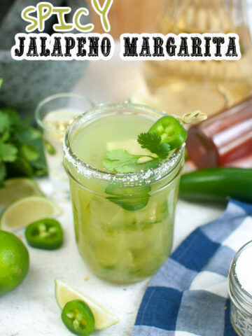 Spicy Jalapeno Margarita with all the ingredients laying around the glass