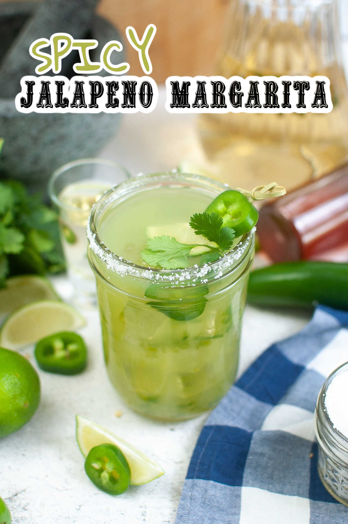 Spicy Jalapeno Margarita with all the ingredients laying around the glass