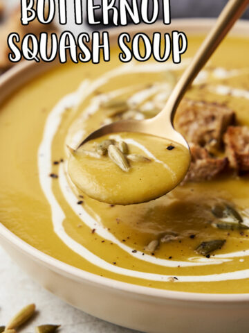 Easy Butternut Squash Soup recipe in a white bowl with a golden spoon.