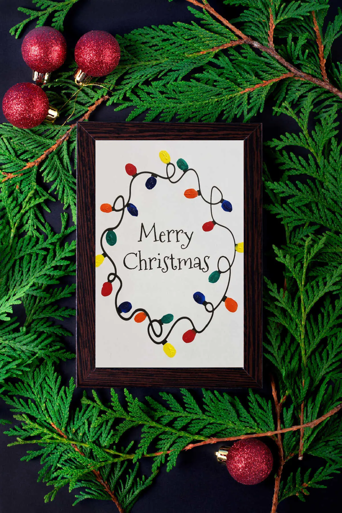 Fingerprint Christmas Lights Printable in a black frame on a Christmas background