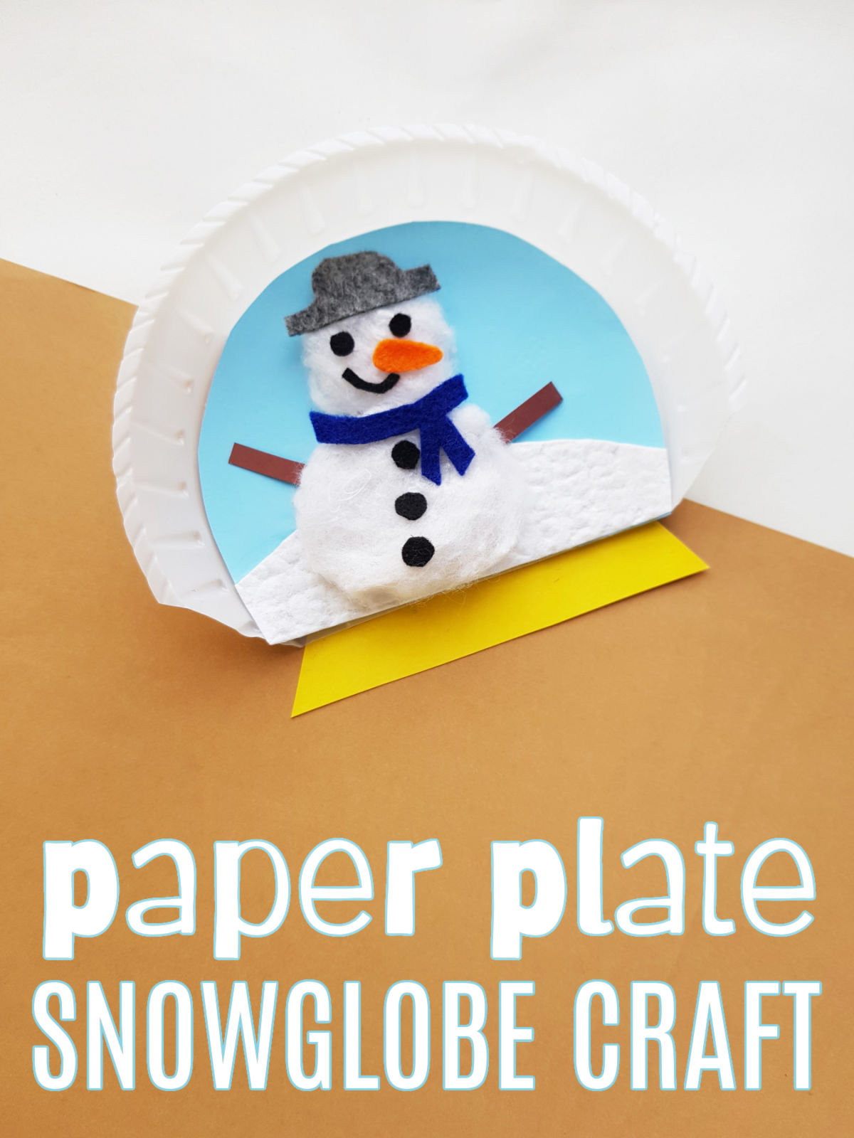 Paper Plate Snow Globe Craft on a white and brown background.