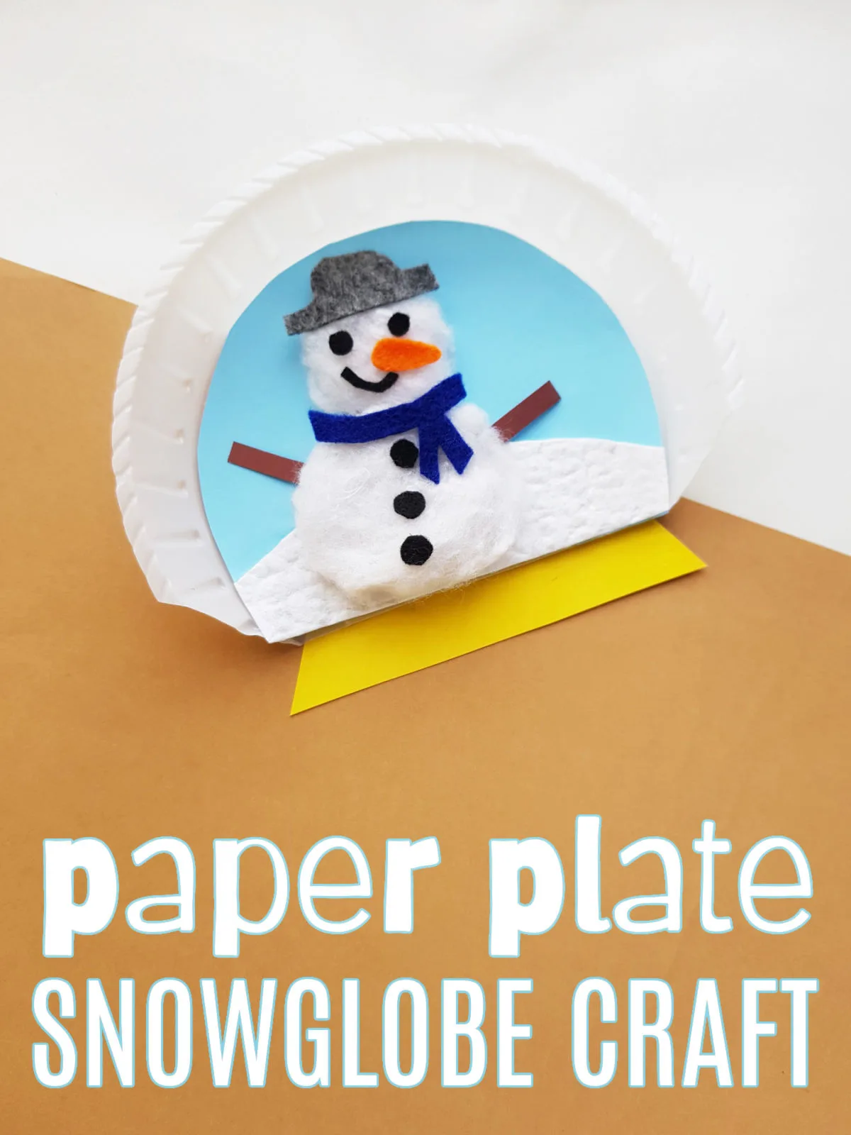 Paper Plate Snow Globe Craft on a white and brown background.