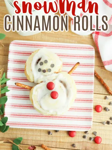 Snowman Cinnamon Rolls on a striped red and white plate.