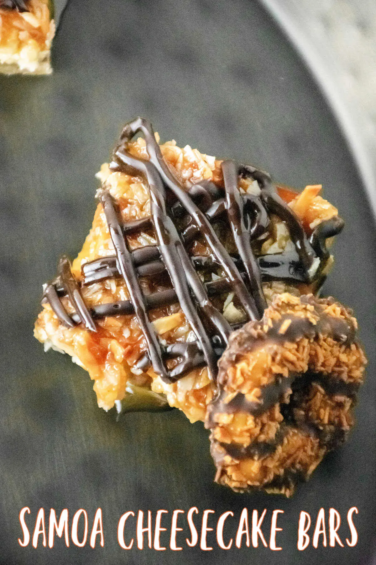 Samoa Cheesecake Bars cut and placed beside a girl scout Samoa Cookie