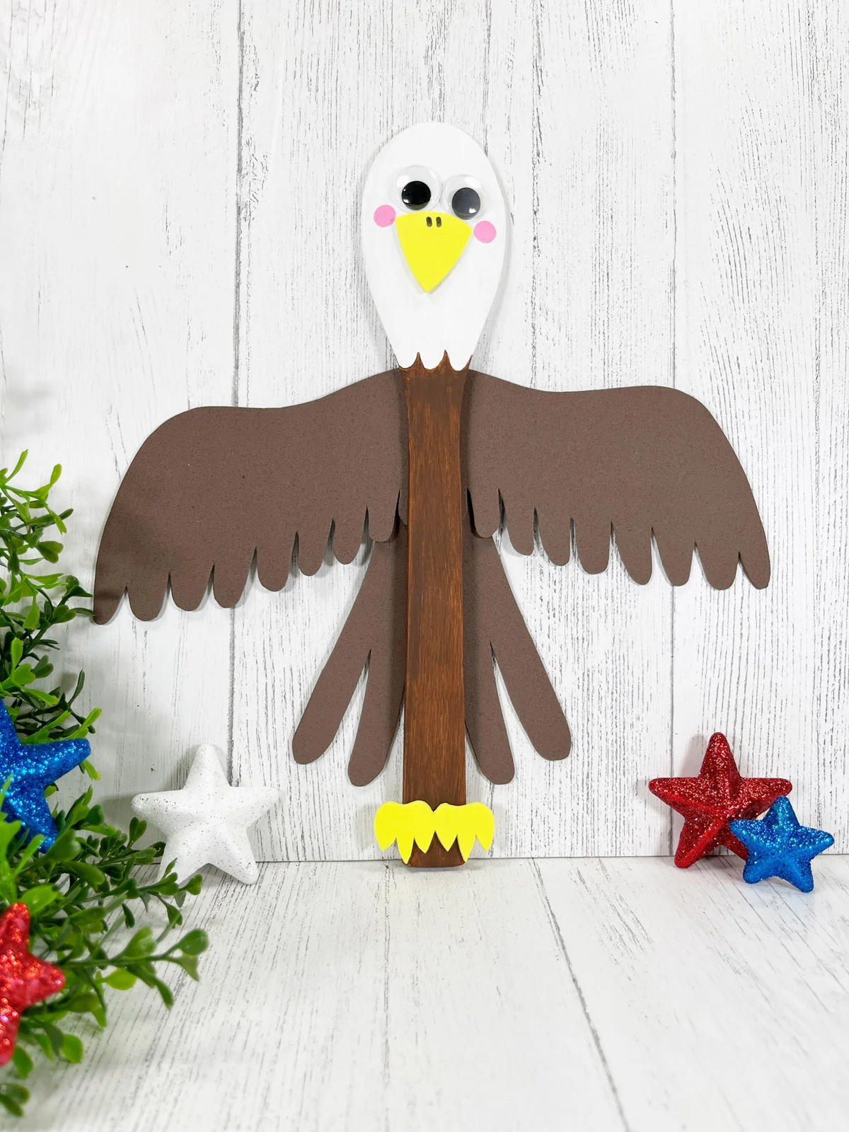 Wooden Spoon Eagle Craft on a white wooden background