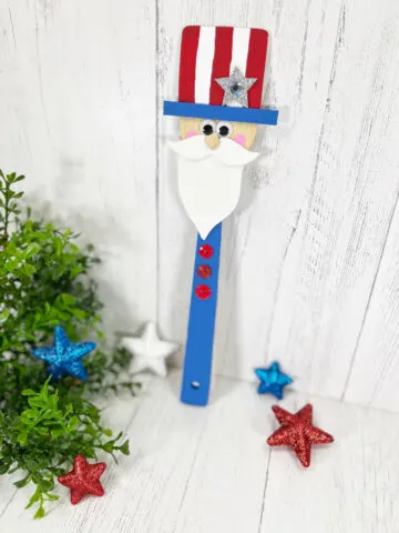 Wooden Spoon Uncle Sam Craft on a white wooden background.