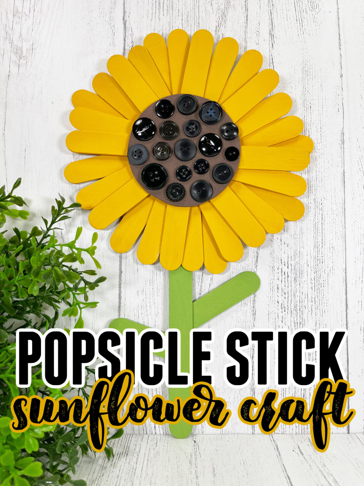Popsicle Stick Sunflower Craft on a white wooden background