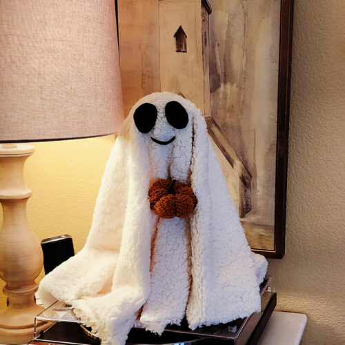 Ghost made with sherpa fabric, felt, and a pumpkin pick.